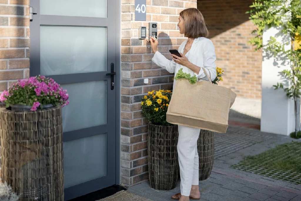 Woman Coming Home with Groceries and Enters a Code
