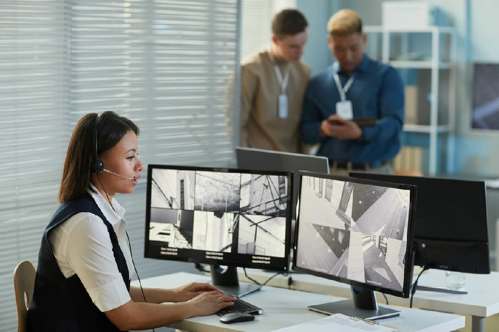 Young Woman Watching Surveillance Camera