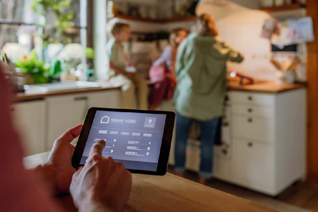 Man using smart thermostat adjusting lowering